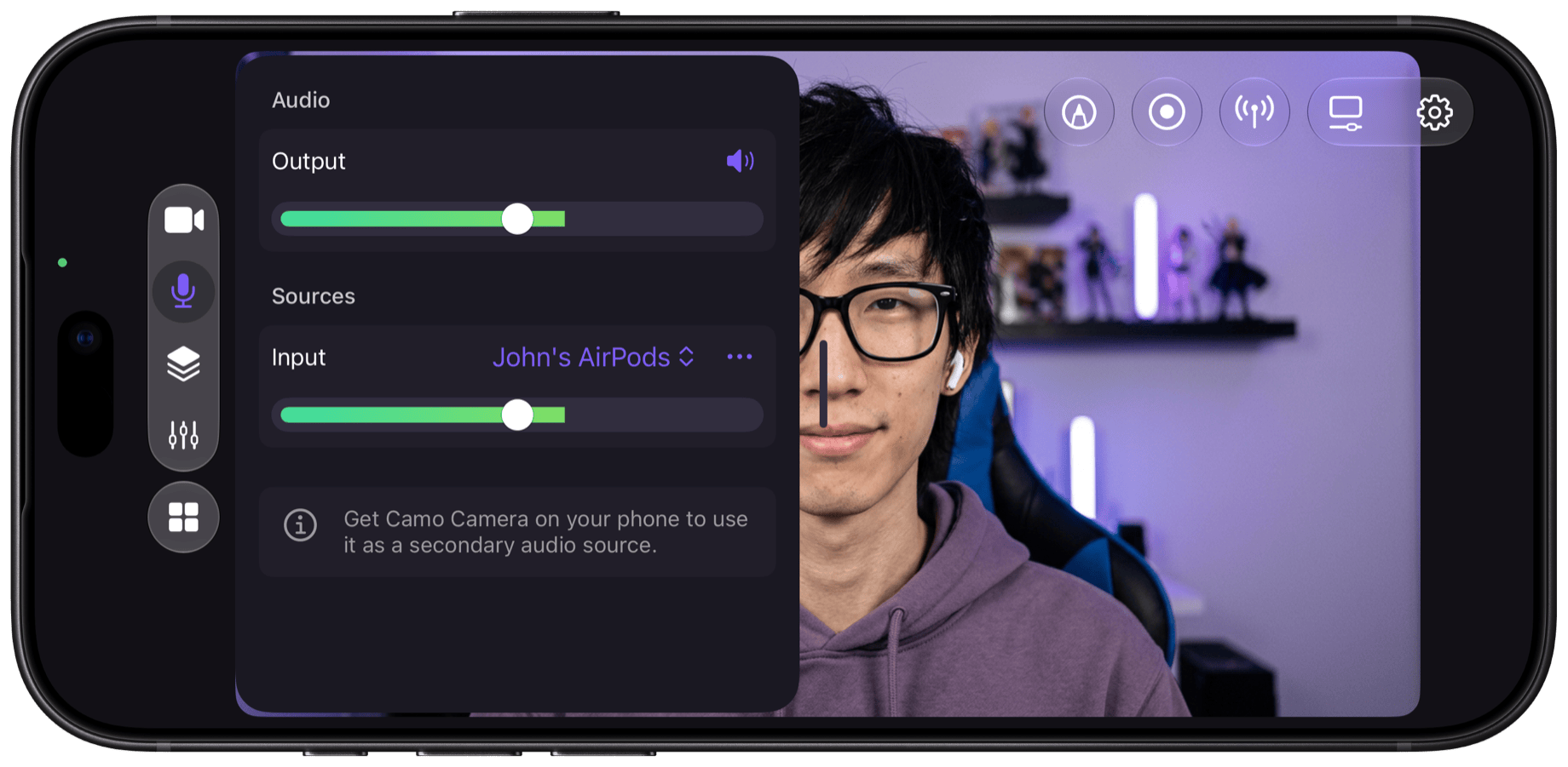Camo Studio on iPhone in landscape: the Audio panel with an output level, AirPods selected as the input source with its own level, and a creator at a desk behind it