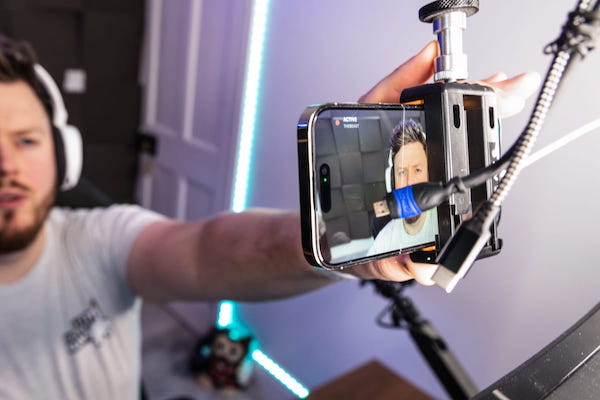 Streamer adjusting phone running Camo